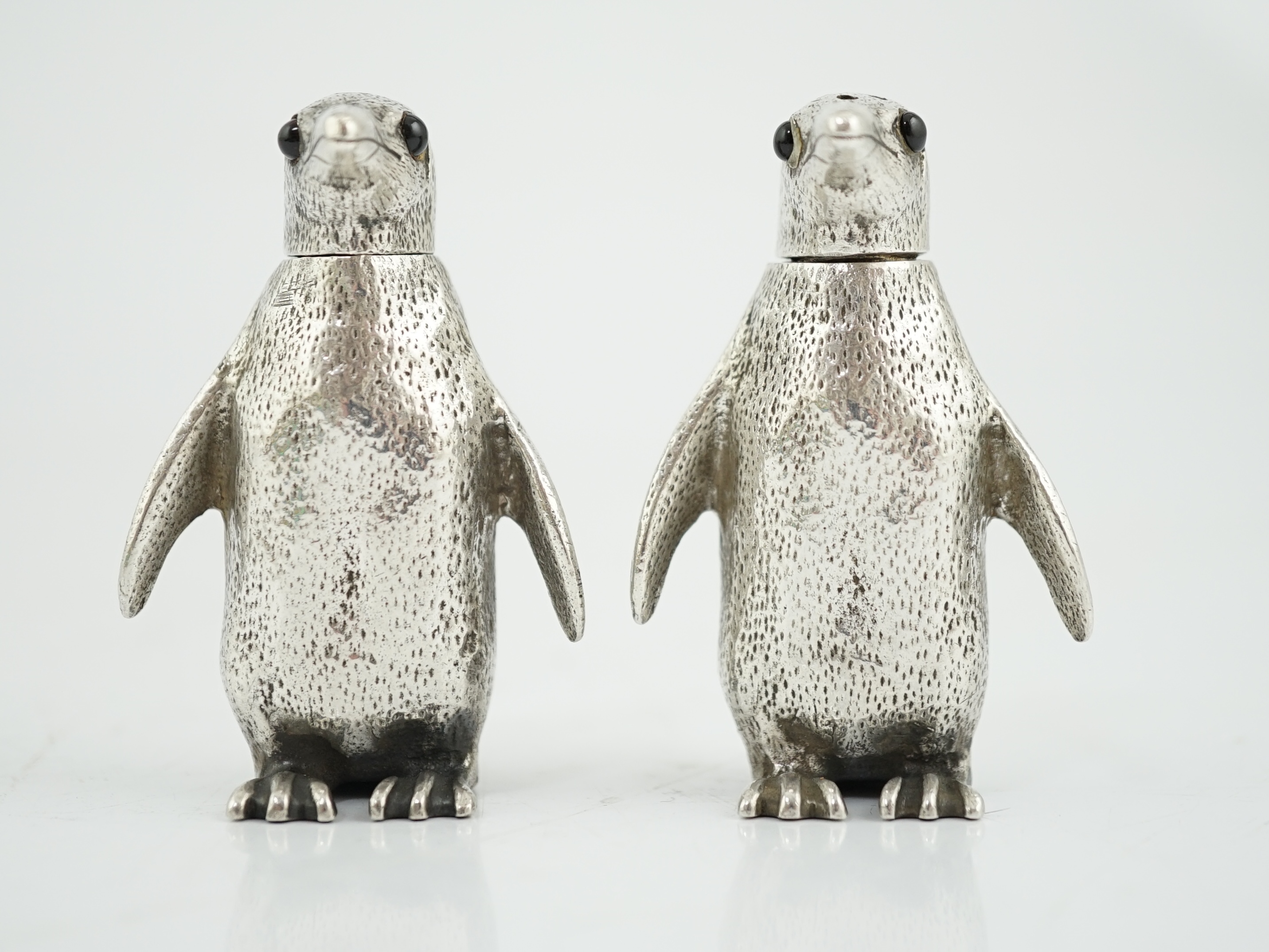 A pair of Elizabeth II silver novelty condiments, modelled as penguins, William Comyns & Sons Ltd